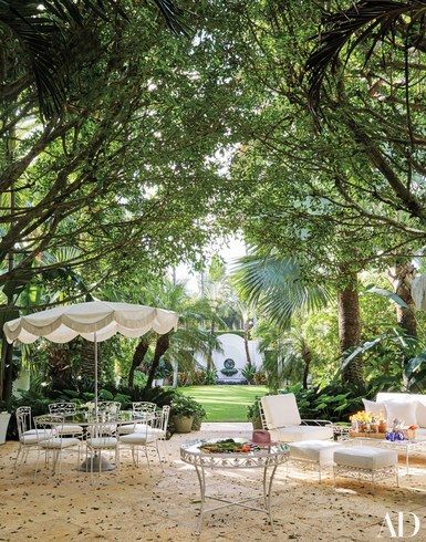 A large outdoor area with tables, chairs and umbrellas.