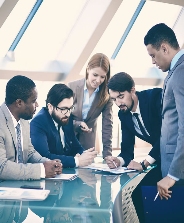 A group of people sitting around a table.