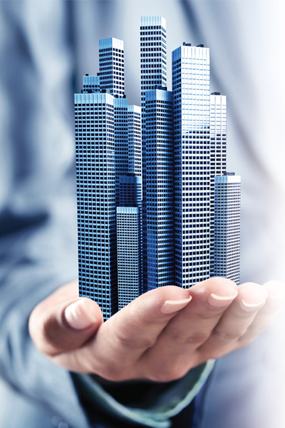 A person holding a model of a city.